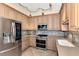 Modern kitchen with stainless steel appliances and light wood cabinets at 3393 Grand Vista Ct # 201, Port Charlotte, FL 33953