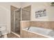 Clean bathroom with shower, soaking tub, and tile flooring at 3393 Grand Vista Ct # 201, Port Charlotte, FL 33953