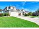 Two-story house exterior with a garage, landscaping and palm tree at 3393 Grand Vista Ct # 201, Port Charlotte, FL 33953