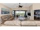 Spacious living room with access to a balcony and bedroom at 3393 Grand Vista Ct # 201, Port Charlotte, FL 33953