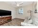 Cozy bedroom featuring a sofa, TV, and large window at 3393 Grand Vista Ct # 201, Port Charlotte, FL 33953