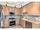 Modern kitchen with stainless steel appliances and light wood cabinets at 3393 Grand Vista Ct # 201, Port Charlotte, FL 33953