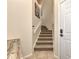 Carpeted staircase with tile flooring and white railings at 3393 Grand Vista Ct # 201, Port Charlotte, FL 33953
