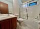 Bathroom with tub, shower, and wood vanity at 412 Cypress Forest Dr, Englewood, FL 34223