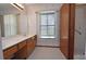 Bathroom with vanity, mirror, and shower at 412 Cypress Forest Dr, Englewood, FL 34223