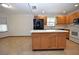 Kitchen with island, wood cabinets, and modern appliances at 412 Cypress Forest Dr, Englewood, FL 34223