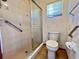 Bathroom with shower stall, toilet, and grab bars at 412 Cypress Forest Dr, Englewood, FL 34223