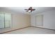 Spacious bedroom with ceiling fan, carpet, and window blinds at 412 Cypress Forest Dr, Englewood, FL 34223