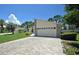 House exterior with paver driveway and landscaping at 412 Cypress Forest Dr, Englewood, FL 34223