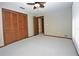 Bedroom with ceiling fan and double door closet at 412 Cypress Forest Dr, Englewood, FL 34223