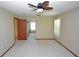 Bedroom with ceiling fan, carpet, and views to another room at 412 Cypress Forest Dr, Englewood, FL 34223