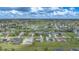 Aerial view of a community with houses, a golf course, and water features at 43 Mark Twain Ln, Rotonda West, FL 33947