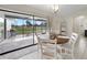 Dining room with sliding glass doors leading to a screened patio overlooking a backyard at 43 Mark Twain Ln, Rotonda West, FL 33947