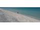 Couple enjoying the beach on a sunny day at 5000 Gasparilla Rd # Dc102, Boca Grande, FL 33921
