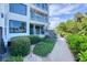 Building exterior with walkway, landscaping, and ocean view at 5000 Gasparilla Rd # Dc102, Boca Grande, FL 33921