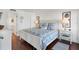 Main bedroom with king-size bed, white furnishings, and hardwood floors at 5000 Gasparilla Rd # Dc102, Boca Grande, FL 33921