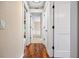 Bright hallway with hardwood floors and neutral-toned walls at 5208 Churchill Rd, Port Charlotte, FL 33981