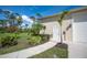 Garage exterior with a separate entrance and landscaping at 5208 Churchill Rd, Port Charlotte, FL 33981