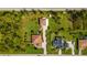 Aerial view of two houses on a large lot with lush landscaping at 5208 Churchill Rd, Port Charlotte, FL 33981