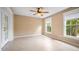 Bright bonus room with tile floors, ceiling fan, and access to backyard at 5208 Churchill Rd, Port Charlotte, FL 33981
