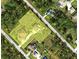 Aerial view shows property with surrounding lots and neighborhood, conveniently located near local amenities at 5208 Churchill Rd, Port Charlotte, FL 33981