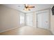 Spacious bedroom with tile floors, ceiling fan, and double closets at 5208 Churchill Rd, Port Charlotte, FL 33981