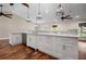 Kitchen island with white cabinets, granite countertops, and hardwood floors at 5208 Churchill Rd, Port Charlotte, FL 33981