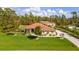 Single-Gathering home with a spacious lawn and palm trees at 5208 Churchill Rd, Port Charlotte, FL 33981