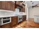 View of kitchen with stainless steel appliances and hardwood floors at 5208 Churchill Rd, Port Charlotte, FL 33981