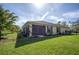 House exterior with screened porch and fenced backyard at 5208 Churchill Rd, Port Charlotte, FL 33981