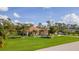 One-story house with a well-maintained lawn and tropical landscaping at 5208 Churchill Rd, Port Charlotte, FL 33981