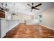 An open-concept living space with hardwood flooring and great light from the surrounding windows at 5208 Churchill Rd, Port Charlotte, FL 33981