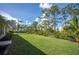 Landscaped backyard with lush lawn and mature trees at 5208 Churchill Rd, Port Charlotte, FL 33981