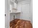 Convenient laundry room with built-in cabinetry and hardwood floors at 5208 Churchill Rd, Port Charlotte, FL 33981