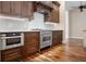 Close up of kitchen with stainless steel appliances and hardwood floors at 5208 Churchill Rd, Port Charlotte, FL 33981