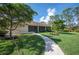 House exterior with walkway and lush landscaping at 5208 Churchill Rd, Port Charlotte, FL 33981