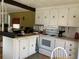 Quaint kitchen with white cabinets and modern appliances at 5560 Holiday Park Blvd, North Port, FL 34287