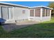 Home features a large sunroom and grassy backyard at 5560 Holiday Park Blvd, North Port, FL 34287