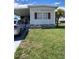 Charming single-wide mobile home with a manicured lawn at 5560 Holiday Park Blvd, North Port, FL 34287