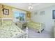 Guest bedroom with two twin beds and a desk at 6600 Gasparilla Pines Blvd # 208, Englewood, FL 34224