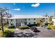 Complex overview: showcasing building and parking at 6600 Gasparilla Pines Blvd # 208, Englewood, FL 34224