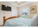 Bedroom with queen-size bed and backyard view at 665 Rotonda Cir, Rotonda West, FL 33947