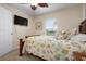 Charming bedroom with a full-size bed, flat-screen TV, and ceiling fan at 665 Rotonda Cir, Rotonda West, FL 33947