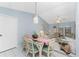 Bright dining area with glass-top table and wicker chairs at 7012 Denmark St, Englewood, FL 34224