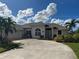 House exterior with driveway and landscaping at 93 Fairway Rd, Rotonda West, FL 33947