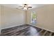 Simple bedroom with dark laminate floors and a large window at 10459 Alexandria Ave, Englewood, FL 34224