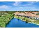 Aerial view of a house near a pond with a backyard at 10852 Lerwick Cir, Englewood, FL 34223