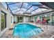 Enclosed pool and patio area with seating at 137 Wahoo Dr, Rotonda West, FL 33947