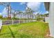 Large backyard with a white fence and grassy area at 137 Wahoo Dr, Rotonda West, FL 33947