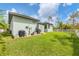 View of backyard, shed, and green lawn at 137 Wahoo Dr, Rotonda West, FL 33947